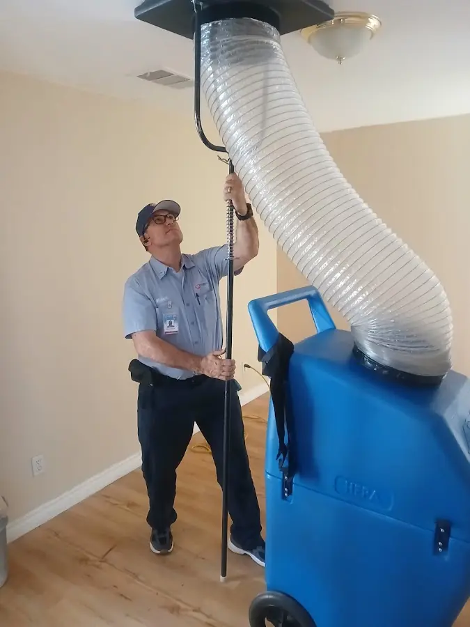 Furnace Tune-Up technician using HEPA equipment in Natchez